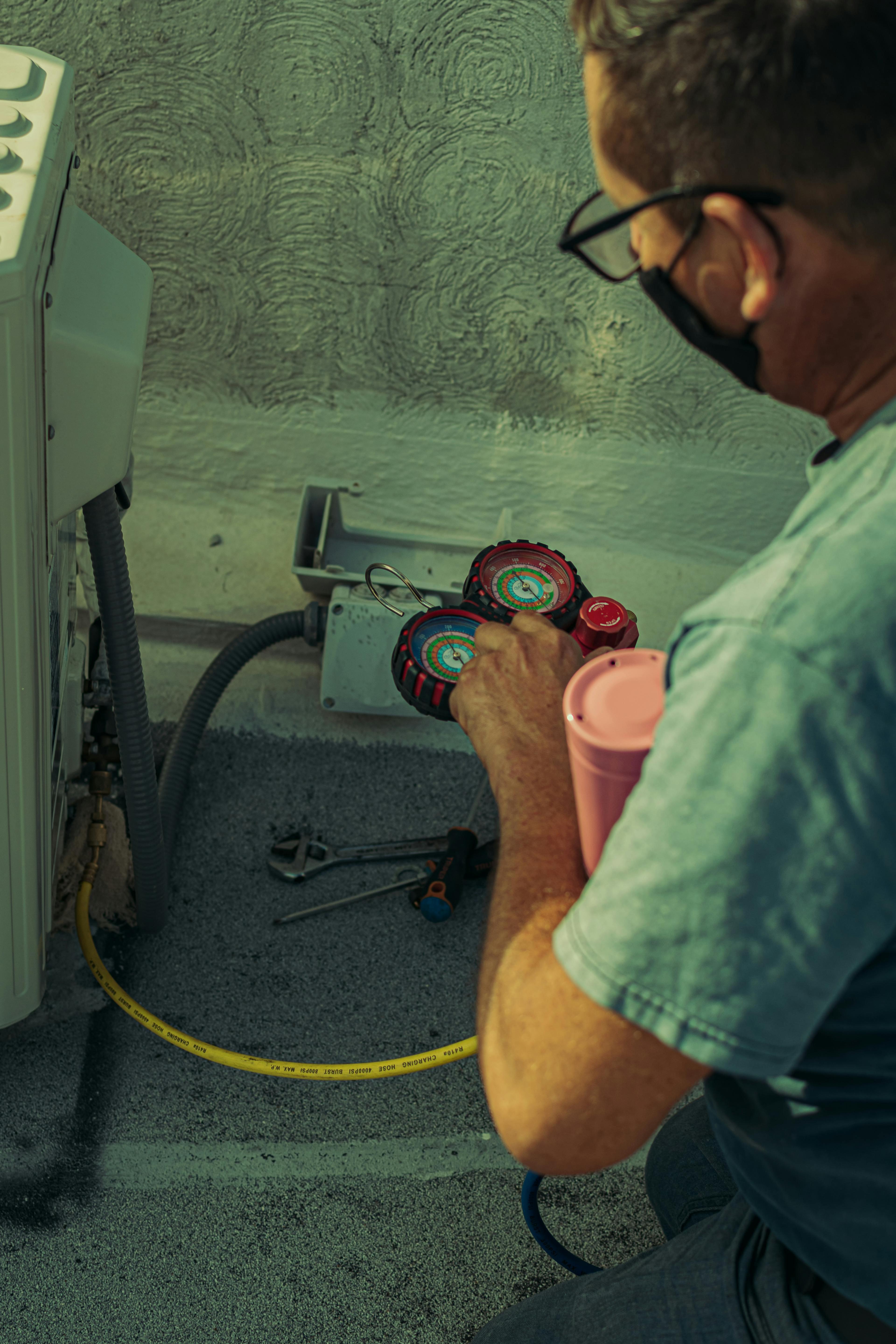 Technician checking an outdoor AC condenser unit at a residential home