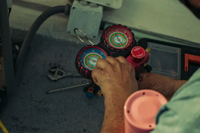 Close view of refrigerant gauges hooked to an air conditioner