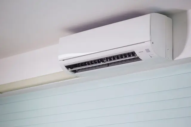 Ductless mini-split air handler mounted high on a wall